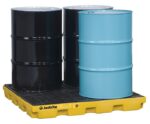 Three black and one light blue industrial drums sit on a yellow Justrite Accum Ctr, 4 Drum, Ecopoly Yel spill containment pallet, designed to prevent leaks and spills while ensuring safety in industrial environments.