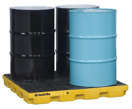 Three black and one light blue industrial drums sit on a yellow Justrite Accum Ctr, 4 Drum, Ecopoly Yel spill containment pallet, designed to prevent leaks and spills while ensuring safety in industrial environments.