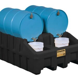 Four blue barrels sit on a Justrite Drum Mgmt Base, Ecopoly, Blk, with two white buckets catching liquid from taps for safe fluid dispensing and storage.