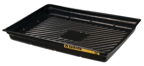 The Justrite Tray, Spill 47x33 Ecopoly in black plastic, features raised ridges and a small center square. A partially visible yellow label reveals its effective spill management with ease and reliability.