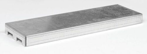 A rectangular metal drain grate with a textured surface and two slots on one side features a rugged design similar to that of a Justrite Shelf, 2G Mini Cabinet. It rests on a light gray background, angled to give depth and dimension.