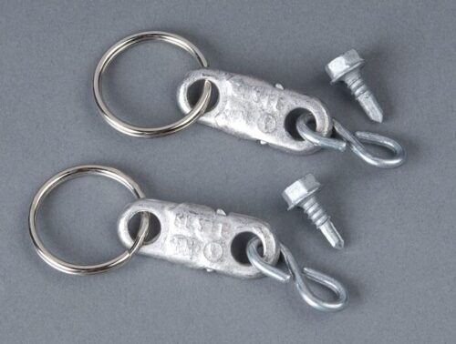 Two metal keychains, designed to mimic the durability of a Justrite Fusible Link Replcmt F/Cabinet, rest on a gray background. Each includes a circular ring and detachable screw-in clasp, with two replacement screws beside them for easy maintenance.