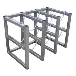 Three Justrite Gcyl Barricade Racks, product code 3X2, Ss, are arranged in parallel. Each features a rectangular frame and chains for securing bicycles, offering sturdy support for cyclists to park and lock their bikes outdoors.