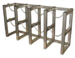 The Justrite Gcyl Barricade Rack,4X1,Ss features four rectangular frames with horizontal bars and chains for crowd control or security. Its metallic finish offers durability and distinctive style in managing public spaces.
