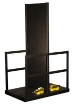 The Justrite Gcyl Fklft Pllt,12Cyl,Fw,Endld is a robust black metal platform with a tall back panel, side rails, and an industrial design. It features a sturdy base secured by two yellow ratchet straps for safely holding or displaying items.