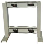 A durable Justrite Gcyl Stnd,4Cyl,B2B,Stl with a rectangular frame includes adjustable supports and two black securing straps. Ideal for vertical surfaces with angled side legs and a light gray finish, perfect for B2B installations.
