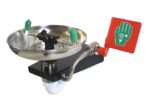 The Justrite H emergency eye wash station, with its open SS bowl, features dual green nozzles and a red activation lever. Mounted on a sleek black base, it includes a pictogram displaying a hand and eye for guidance.