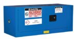 The Justrite Cabinet Haz M Pigy Chmc 12G Sc is a blue metal storage unit with a black handle, labeled for hazardous materials, and features caution signs and warnings to keep fire away for secure chemical storage.
