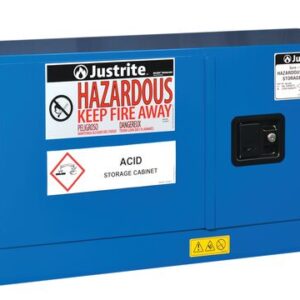 The Justrite Cabinet Haz M Pigy Chmc 12G Sc is a blue metal storage unit with a black handle, labeled for hazardous materials, and features caution signs and warnings to keep fire away for secure chemical storage.