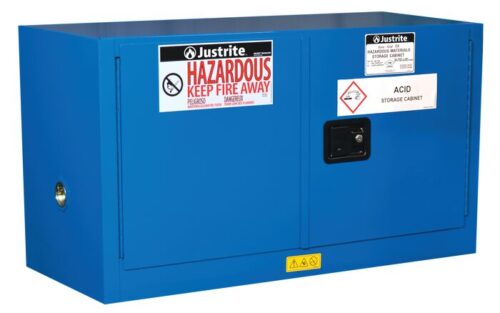 861728.jpg The Justrite Cabinet in blue, designed for acid and Haz Mat Pigybk 17G Sc storage, features labels HAZARDOUS KEEP FIRE AWAY and ACID STORAGE CABINET, along with a black handle and warning symbols to ensure safe storage.
