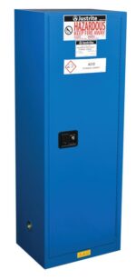 A tall blue Justrite Cabinet labeled Acid Storage Cabinet is covered with warning labels such as Hazardous and Keep Fire Away. This Haz M Slm Chmc 22G Sc unit is securely closed with a black handle.