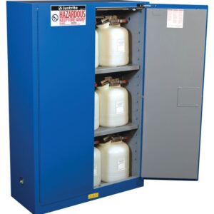 The Justrite Cabinet Haz Mat Chemcor 45G Sc, painted blue and labeled Hazardous: Keep Fire Away, stands open with shelves holding white plastic containers, ensuring safe chemical storage.