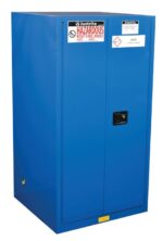 A blue Justrite Cabinet, Haz Mat Chemc 60G Sc, with two doors and a small black central handle, is decorated with warning signs including Hazardous and Keep Fire Away, designed for acid storage.