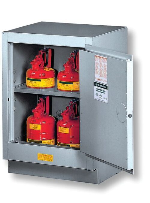 The Justrite Cabinet Fmhd 15G/24 Man/L Slv, a sleek silver unit, stores four red safety gas cans with black handles and yellow labels on its shelves. The open door displays clear safety instructions.