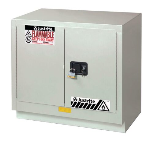 883607.jpg The Justrite Cabinet FMHD 23G/36 Man Ltnul is a gray cabinet with two padlock-secured doors, showcasing warning labels and safety symbols that prominently display Flammable and Keep Fire Away for enhanced safety.