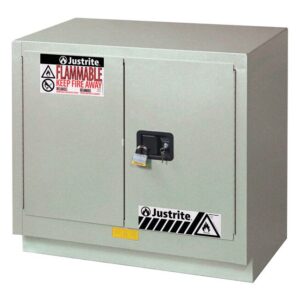 The Justrite Cabinet Fmhd Chmc 23G Man Slv is a gray metal flammable storage unit with two doors, a black handle, and a padlock. It includes fire hazard labels, ensuring safety by mitigating fire risks.