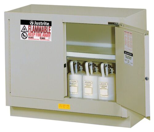 The Justrite Cabinet Fmhd 31G/48 Sc Slv, featuring a beige exterior with bold Flammable and Keep Fire Away warnings, showcases three white safety canisters inside, highlighting its meticulous design for safety in hazardous environments.