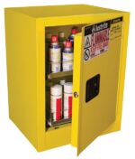 A yellow Justrite Cabinet, Aero Bntp 4G, Man Yel is seen with the door slightly open showing shelves filled with bottles and containers. Warning labels for flammable materials and safety instructions adorn the cabinet, ensuring secure storage.