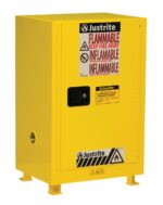 The Justrite Cab Bshock Flam Cmp 12G Sc Yel is a yellow safety cabinet with Flammable Keep Fire Away in bold red, a sturdy black handle, and is designed for securely storing flammable liquids with clear warning symbols.