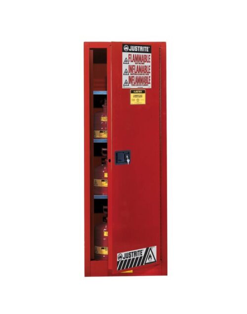 A tall Justrite Cabinet, Flam Slm 22G, Sc Red stands with its door slightly open, revealing shelves lined with flammable liquid containers. Multiple Flammable warning labels in English and Spanish adorn it for clear caution messaging.