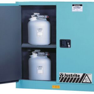 A teal Justrite Cabinet, Acid Chmc 30G Man Blu, is open, displaying two gray containers on separate shelves. Each container has a secure lid and clear safety labels.