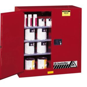 A Justrite Cabinet, Cmbs P&I 40G, Man Red stands open with its shelves filled with cans and containers. A warning label emphasizes its safety features. Ideal for securely storing flammable materials, this cabinet is essential for any safe workspace.