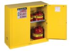 Explore the Justrite Cabinet, Flam Sfty 30G, in striking SC Yel. Its open doors reveal red flammable liquid containers on two shelves, with safety labels clearly stating Flammable and Keep Fire Away.