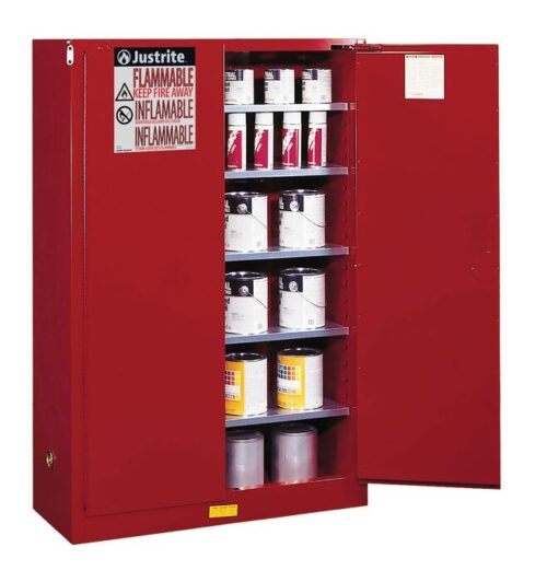 A Justrite Cabinet, Cmbs P&I 60G Man Red, is open, displaying its red flammable storage design. Shelves filled with labeled containers and a clear Flammable: Keep Fire Away sign highlight its role. Its robust industrial build makes it vital for safety in any environment.