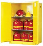 A Justrite Cabinet, model Flam Sfty 90G Man Yel, showcases open doors with red metal safety cans with yellow bands on the bottom and middle shelves and neatly arranged funnels on the top shelf, all engineered for safe flammable liquid storage.
