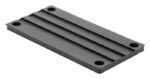 The Justrite Chock, model 3512, includes a rectangular metal base plate with four corner holes and two parallel grooves along its length.