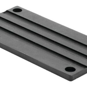 The Justrite Chock, model 3512, includes a rectangular metal base plate with four corner holes and two parallel grooves along its length.