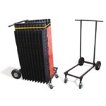 A set of black stackable Justrite CP barriers with red accents and a grid pattern are folded beside an empty Trans Cart. These wheeled barricades add functionality and style to any setting.