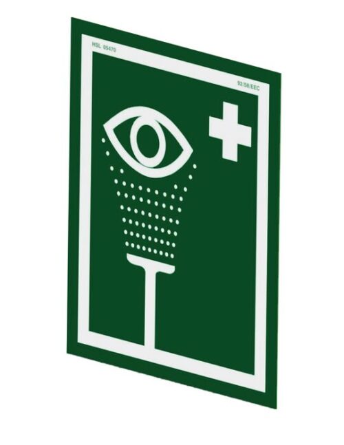 Green and white Justrite H, Ssaccy, Eyewash Sign displaying an eye above a vertical line with droplets, symbolizing an emergency eyewash station. Features a white cross in the top right corner.