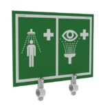 The Justrite H safety sign features white shower and person icons on the left and an eye with a fountain on the right, indicating emergency stations. It’s finished in green, includes two Ssaccy hooks below, and showcases the Eywsh&Shwr Sign&Brckt.