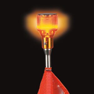 A close-up of the Justrite Whip,Acc,Lgt,Lmp,12V,A,Kit showcases an illuminated orange safety light with a ribbed surface. It emits a warm glow mounted on a pole, with a red reflective flag partly visible against the black background.