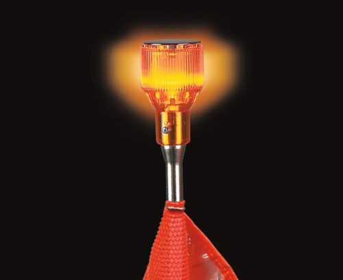 A close-up of the Justrite Whip,Acc,Lgt,Lmp,12V,A,Kit showcases an illuminated orange safety light with a ribbed surface. It emits a warm glow mounted on a pole, with a red reflective flag partly visible against the black background.
