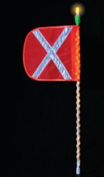 The Justrite Whip features a red flag with a reflective silver X, mounted on an LED-lit pole topped by an illuminated bulb, standing out against a black background.