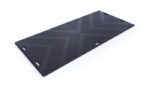 The Justrite Mats Libmat 4X8 black mat features a textured chevron pattern with raised dots for grip and has rectangular edge cutouts for carrying or securing. Set against a plain white background, the design is noticeably sleek.