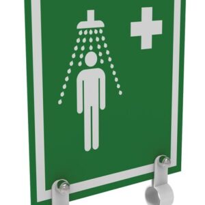 The Justrite H Ssaccy shower sign in green displays a white figure under a showerhead with water droplets and a cross in the top right, mounted on a wall using two white brackets.
