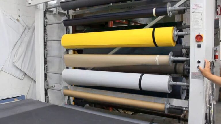 Vidir textile carousel loaded with fabric rolls while an operator uses the control panel