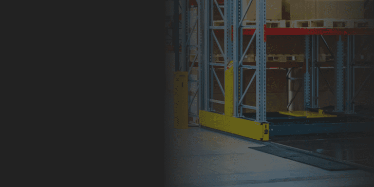Yellow guard rails and column protectors at the base of warehouse pallet racking