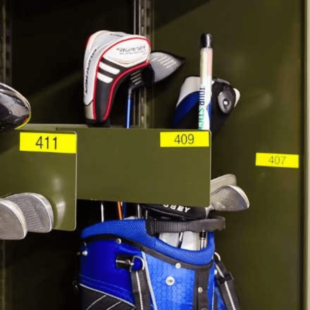 A golf bag with clubs standing in an open storage compartment