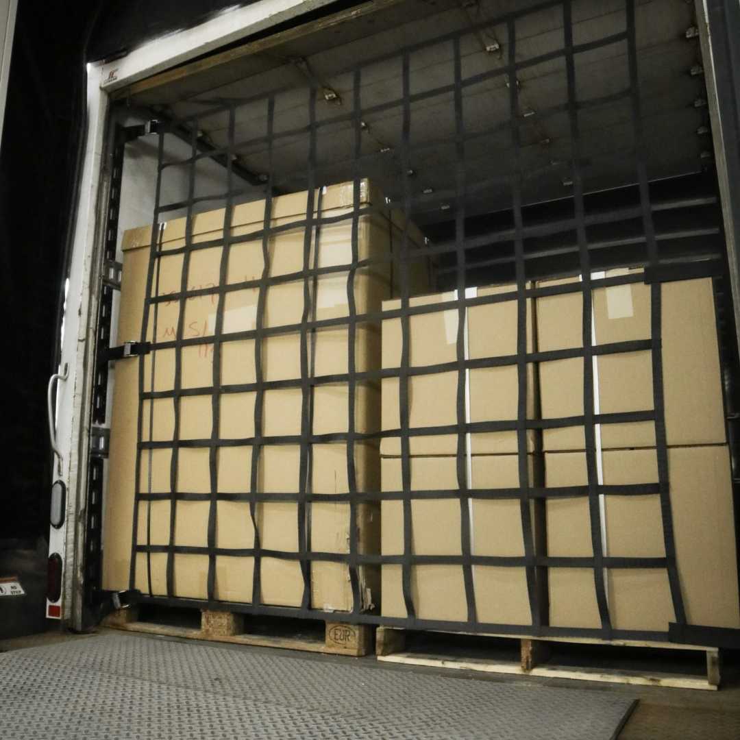 InCord truck net containing palletized freight inside a trailer at the dock