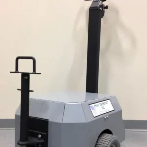 The Electro Kinetic Technologies Pony Express Electric Tugger features a 5000-pound capacity, a round bar hitch, two wheels, a vertical handlebar with control panel, and an under-mounted stabilizing wheel for smooth floor navigation.