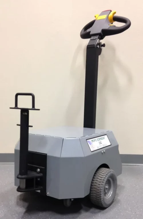 a49cefa9-e8e0-4498-ad5f-9988c273be18_zpsd7f5e7f9.webp The Electro Kinetic Technologies Pony Express Electric Tugger features a 5000-pound capacity, a round bar hitch, two wheels, a vertical handlebar with control panel, and an under-mounted stabilizing wheel for smooth floor navigation.