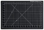 The Dahle Vantage® Premium Self-Healing Cutting Mat, 12 x 18, Black (Case of 24), offers precision with a white grid, inch and millimeter measurements, and angled lines at 45° and 60°, catering to both hobbyists and professionals.