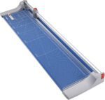 The Dahle 448 Premium Rotary Trimmer, featuring a blue and gray design, includes a grid pattern on the cutting surface, a metal rail, rotary blade mechanism, and safety guard. With its 51 cut length and measurement markings, it ensures precise and safe cuts.