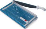 The Dahle 534 Professional Guillotine boasts an 18 cut length, a blue base, and a black blade. It features a white handle for easy use, measurement guides and a red safety lock on the cutting surface, plus paper size templates on the base for precise projects.