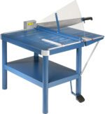 The Dahle 580 Large Format Premium Guillotine, with a 32 cut length, features a blue design, large manual handle, clear safety guard, and spacious cutting surface. It stands on sturdy legs with a lower shelf for additional storage.