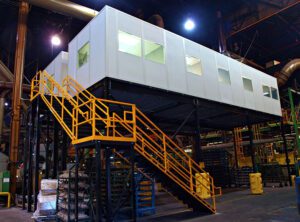 Elevated modular control room with windows supported on a steel structure